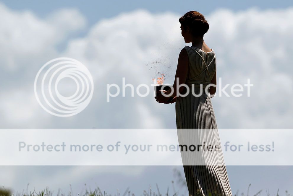 A priestess holding a lit cauldron performs in the final dress rehearsal for the lighting of the flame held on May 9, 2012, in ancient Olympia, Greece. (AP Photo/Petros Giannakouris)