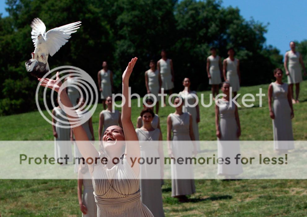 An actress, playing the role of a priestess, releases a dove during the dress rehearsal for the torch lighting ceremony of the London 2012 Olympic Games in Greece, on May 9, 2012.(Reuters/John Kolesidis)
